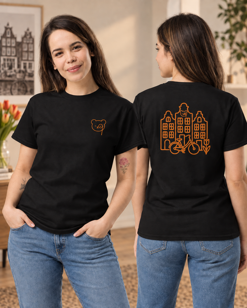 Black T-shirt with a small copper Teddy O’Broin bear-face emblem printed on the left chest.
Back of a black T-shirt featuring copper line art of Amsterdam canal houses, a bicycle, a tulip and the Teddy O’Broin emblem.