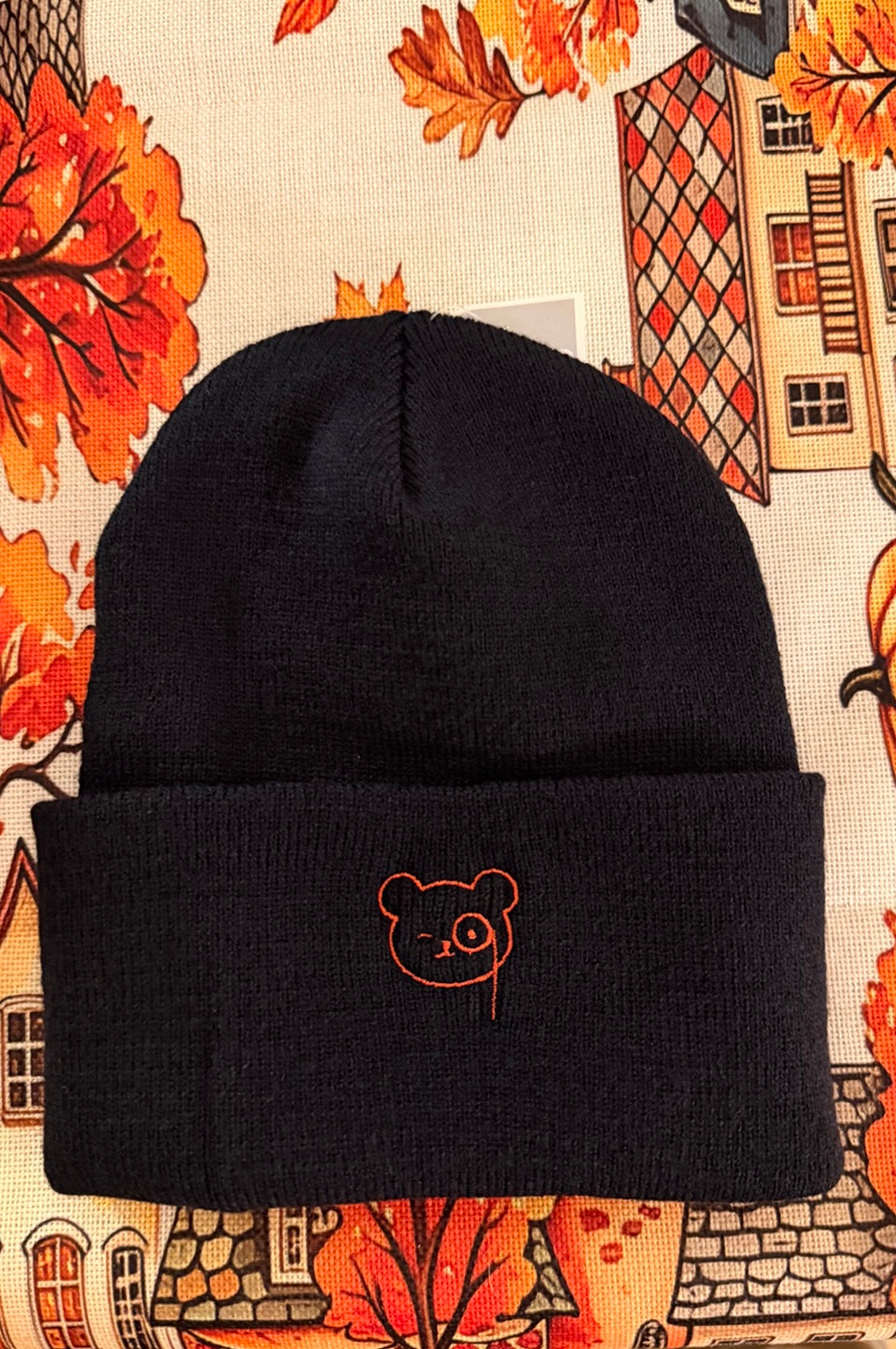 Black cuffed beanie with Teddy O'Broin's face embroidered on the cuff