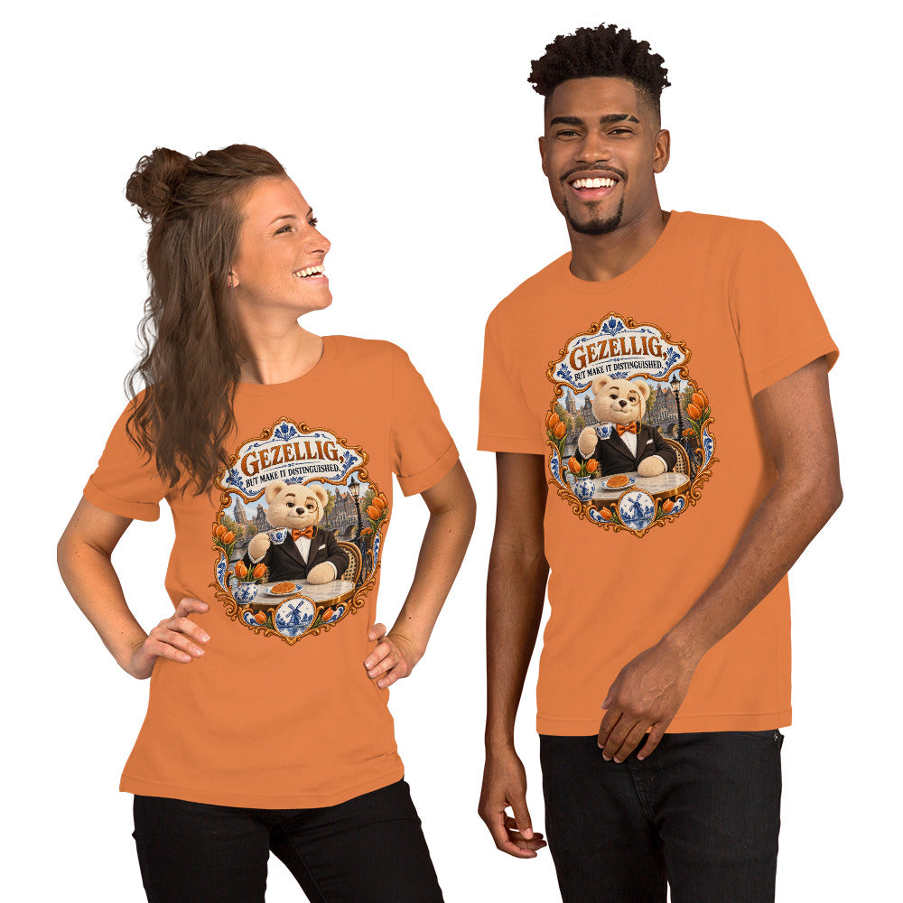 Burnt Orange T-shirt featuring Teddy O’Broin wearing a tuxedo and monocle beside an Amsterdam canal with tulips, a Delft cup and stroopwafel beneath the words Gezellig, But Make It Distinguished.