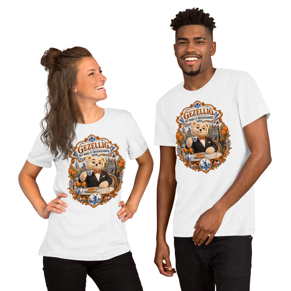 White T-shirt featuring Teddy O’Broin wearing a tuxedo and monocle beside an Amsterdam canal with tulips, a Delft cup and stroopwafel beneath the words Gezellig, But Make It Distinguished.
